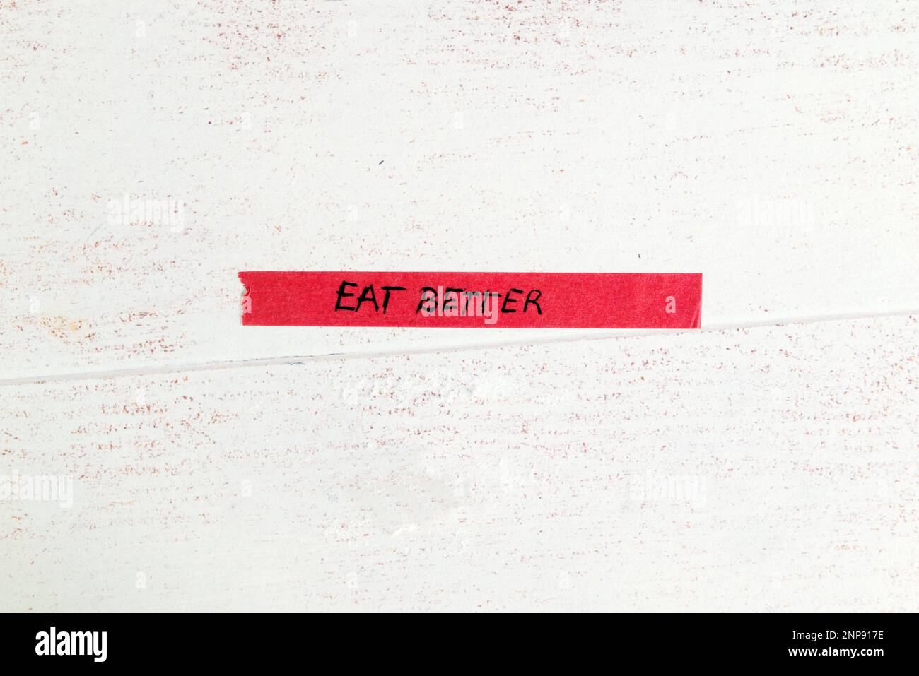 motivational ;eat better' message handwritten on colorful washi tape