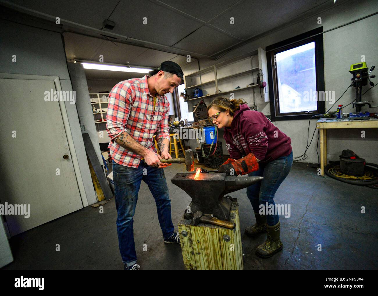 Kyle Farace and his wife, Kaila CumingsFarace, shape a knife at their