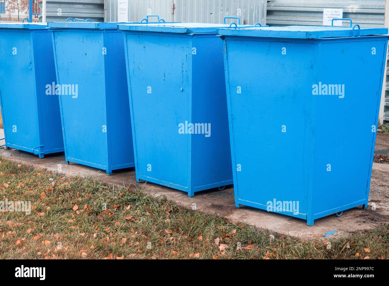 Type of garbage cans. Metal dumpsters stand in row on special site