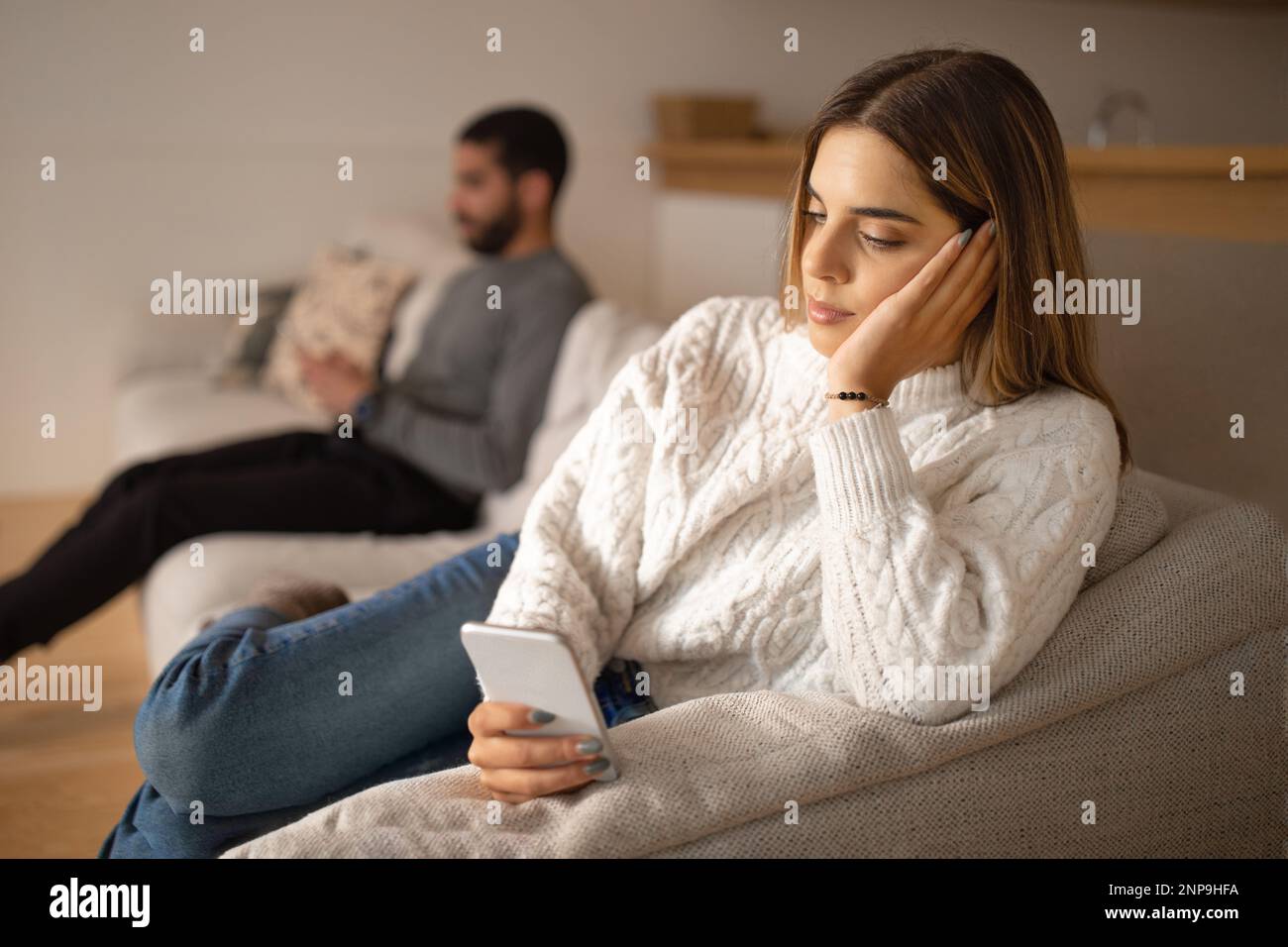 Sad Typing Sad young arab male typing on smartphone and ignoring european woman ...