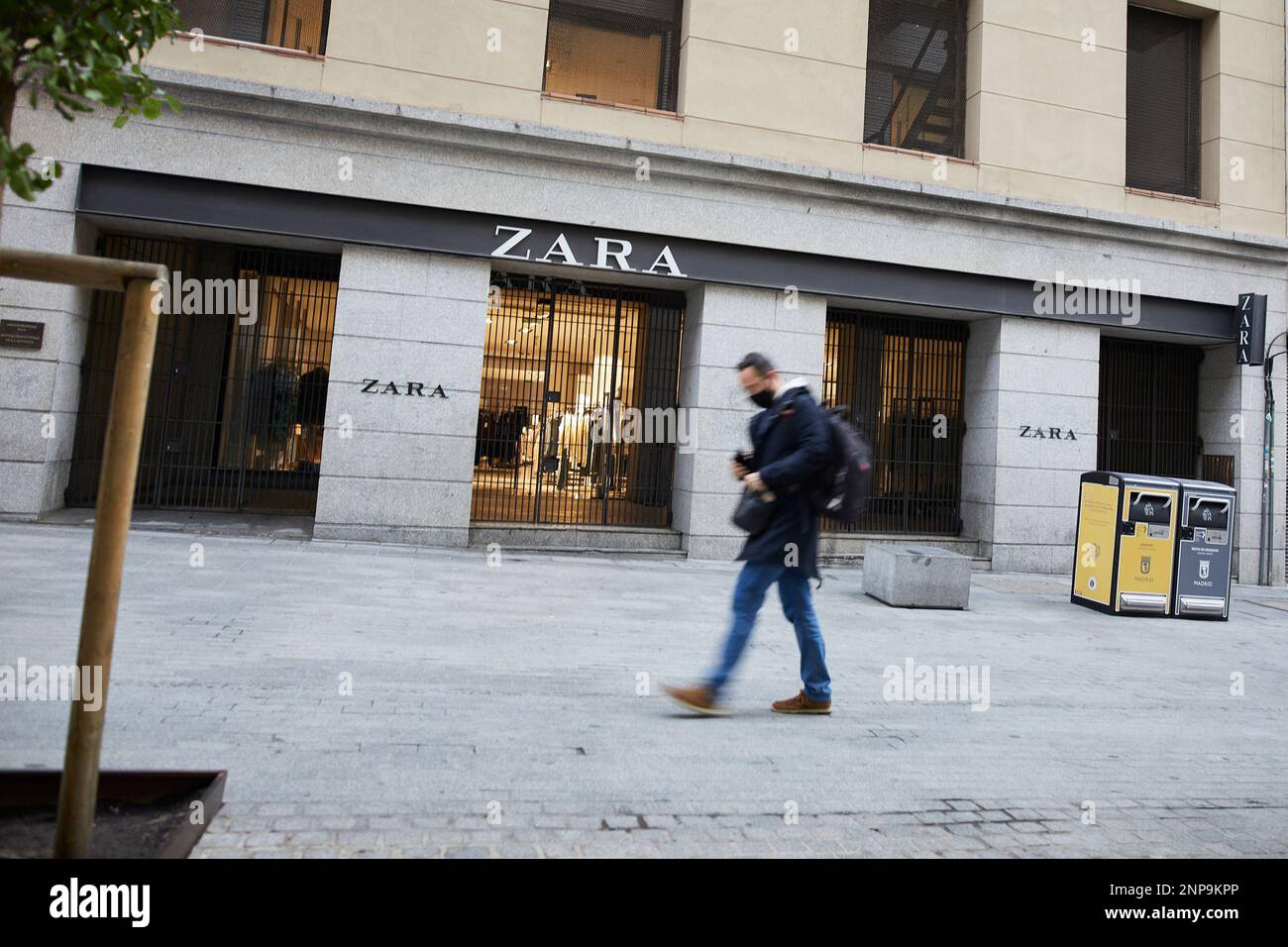 A person passes by the first Zara store that opened in the capital next to  Puerta del Sol, in Madrid, (Spain), on November 14, 2020. The store, which  belongs to the multinational