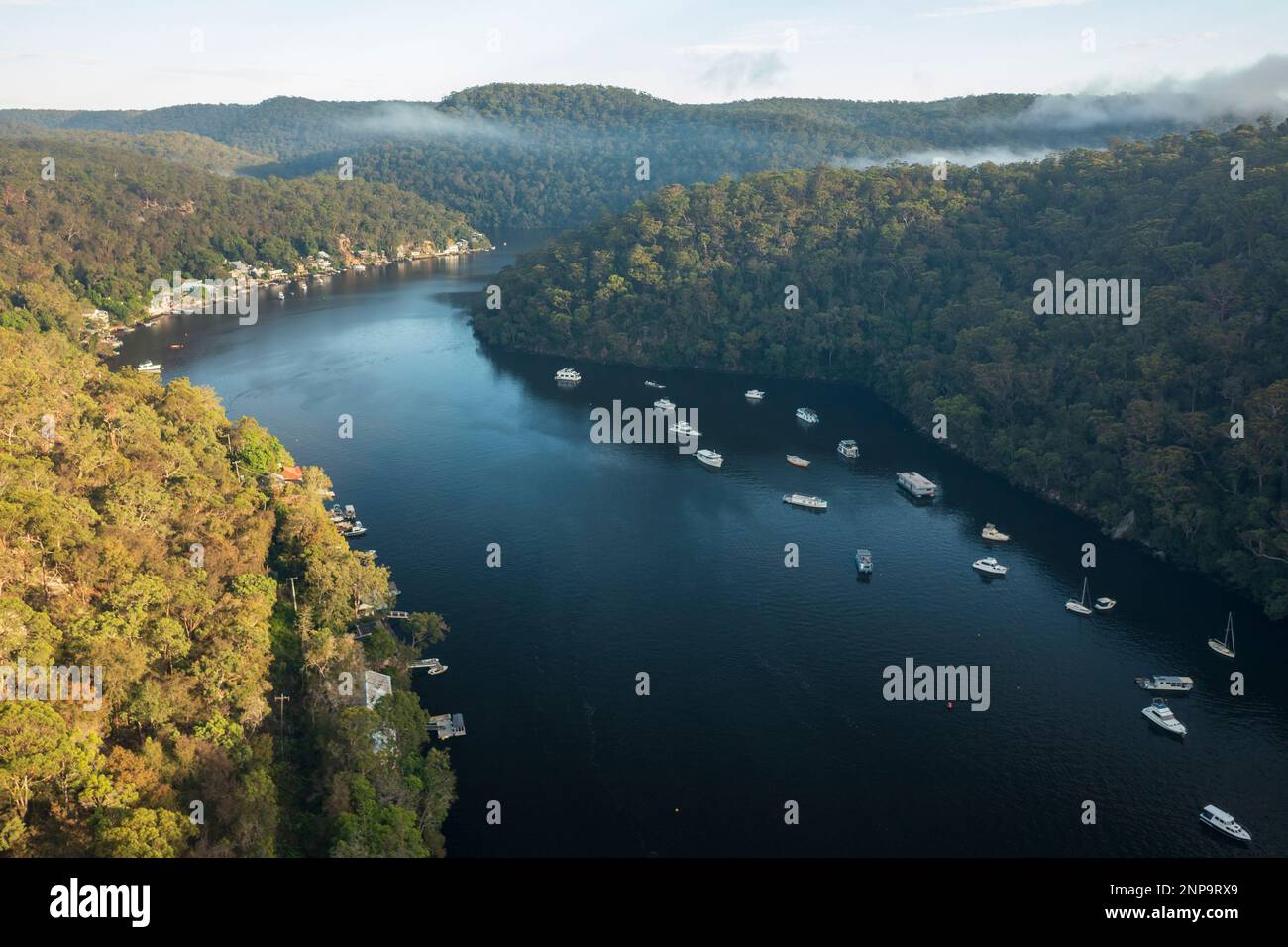 Aerial view of mist rising above scenic Berowra Waters in the early morning. Stock Photo