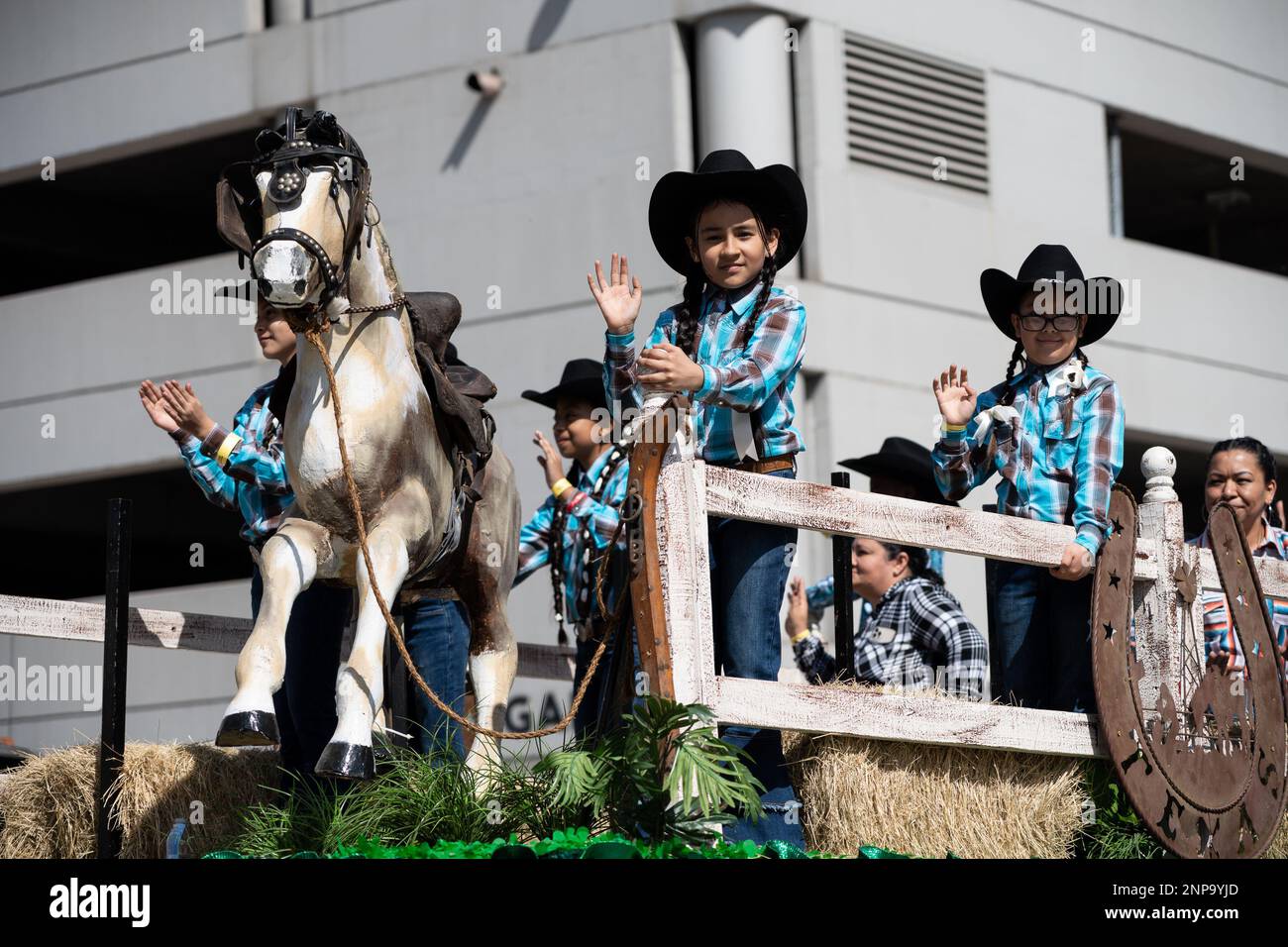 Houston, USA. 25th Feb, 2023. Young cowgirls riding a float are ...
