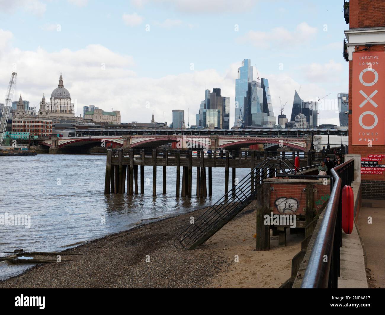 Beach on the south bank of the River Thames with Blackfriars Bridge, St Pauls Cathedral and Skyscrapers behind. London England Stock Photo