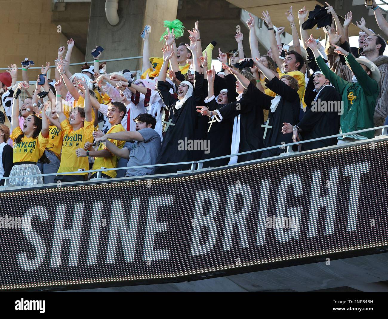 Baylor students cheer as they wear costumes for Halloween during an NCAA college football game