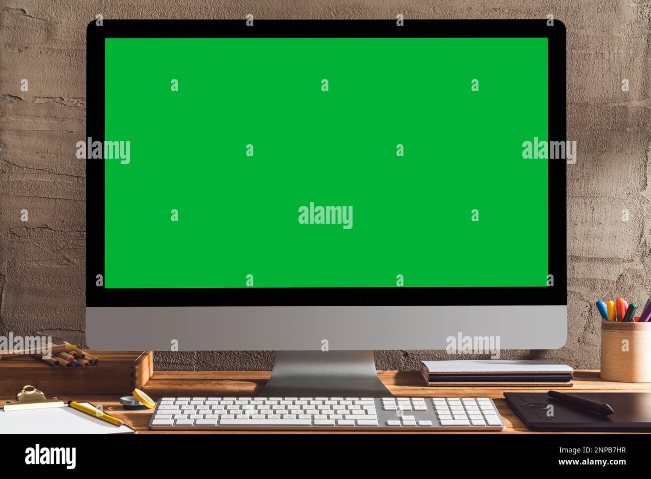 Chroma key green screen computer , desktop pc on table of designer