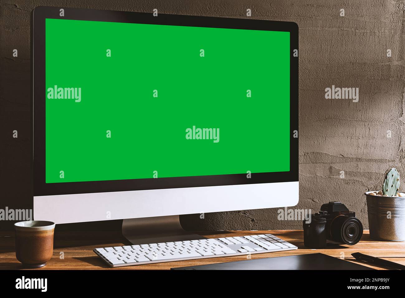 Chroma key green screen, angled view computer on table with digital