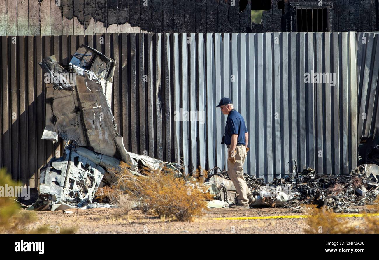 An investigator looks at the site of a deadly plane crash Thursday, Oct