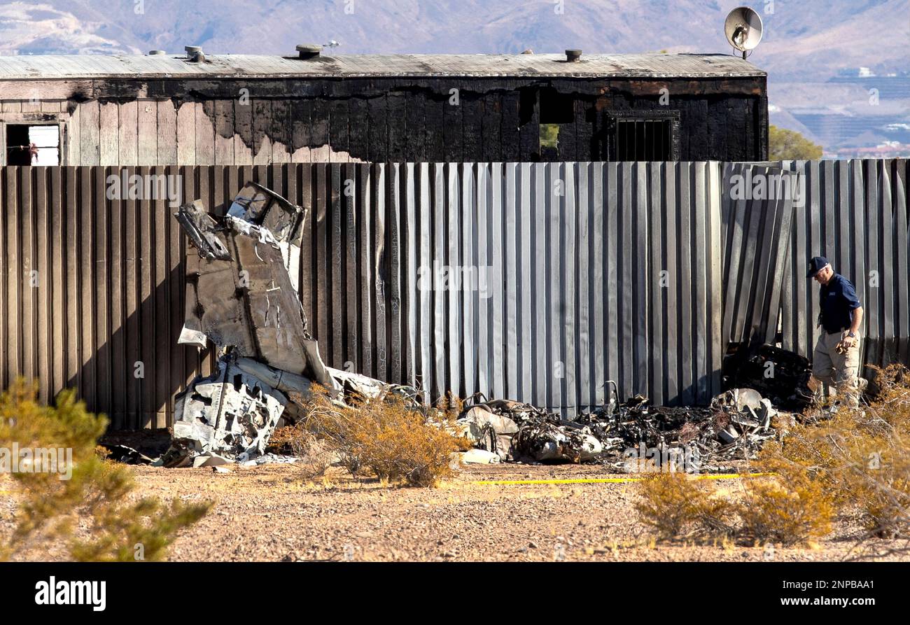 An investigator looks at the site of a deadly plane crash Thursday, Oct