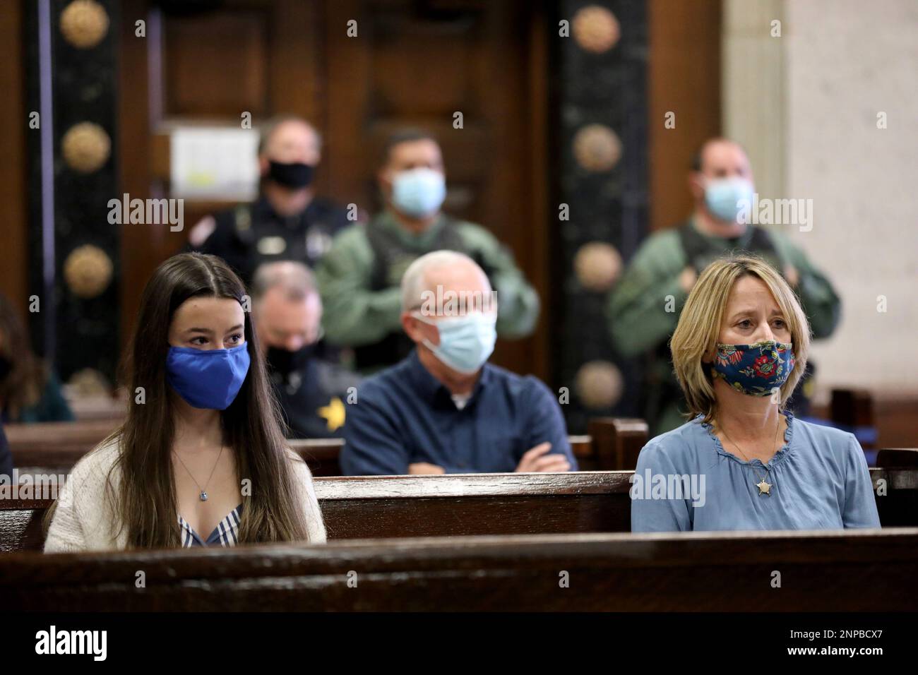 The late Chicago police Cmdr. Paul Bauer's daughter, Grace, and wife, Erin  Bauer, watch as Shomari Legghette, 47, is sentenced in the first-degree  murder trial in the fatal shooting of Chicago police