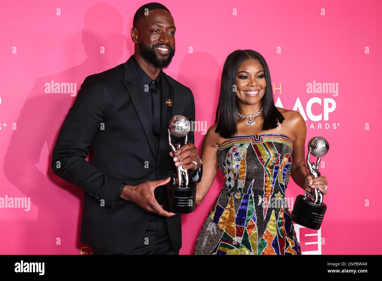 Pasadena, United States. 25th Feb, 2023. PASADENA, LOS ANGELES, CALIFORNIA, USA - FEBRUARY 25: American former professional basketball player Dwyane Wade wearing Versace and wife/American actress Gabrielle Union wearing Atelier Versace SS98 Couture, recipients of the President's Award pose in the press room at the 54th Annual NAACP Image Awards held at the Pasadena Civic Auditorium on February 25, 2023 in Pasadena, Los Angeles, California, United States. (Photo by Xavier Collin/Image Press Agency) Credit: Image Press Agency/Alamy Live News Stock Photo