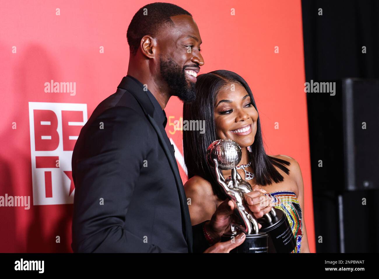 Pasadena, United States. 25th Feb, 2023. PASADENA, LOS ANGELES, CALIFORNIA, USA - FEBRUARY 25: American former professional basketball player Dwyane Wade wearing Versace and wife/American actress Gabrielle Union wearing Atelier Versace SS98 Couture, recipients of the President's Award pose in the press room at the 54th Annual NAACP Image Awards held at the Pasadena Civic Auditorium on February 25, 2023 in Pasadena, Los Angeles, California, United States. (Photo by Xavier Collin/Image Press Agency) Credit: Image Press Agency/Alamy Live News Stock Photo