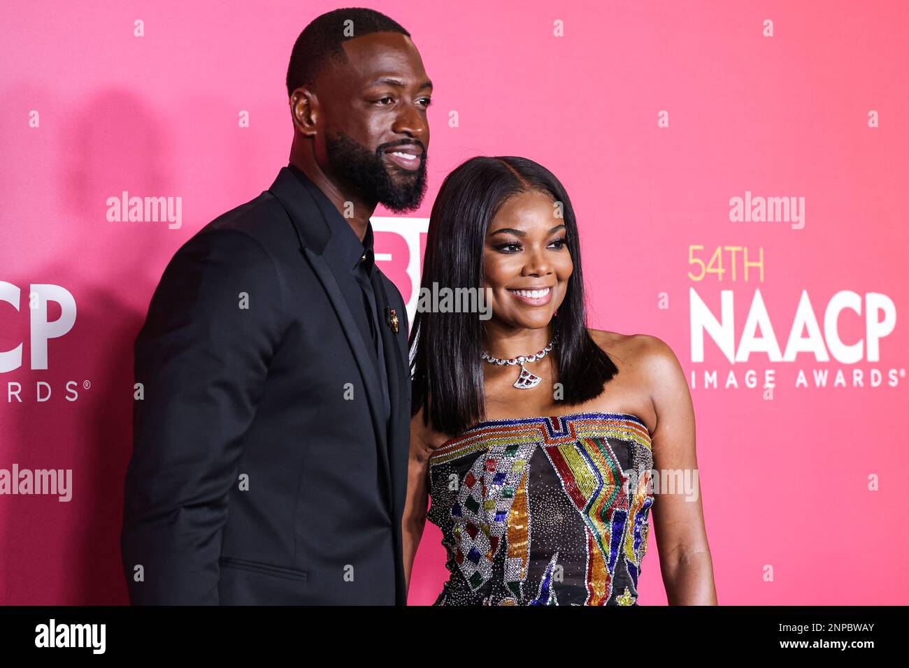 Pasadena, United States. 25th Feb, 2023. PASADENA, LOS ANGELES, CALIFORNIA, USA - FEBRUARY 25: American former professional basketball player Dwyane Wade wearing Versace and wife/American actress Gabrielle Union wearing Atelier Versace SS98 Couture, recipients of the President's Award pose in the press room at the 54th Annual NAACP Image Awards held at the Pasadena Civic Auditorium on February 25, 2023 in Pasadena, Los Angeles, California, United States. (Photo by Xavier Collin/Image Press Agency) Credit: Image Press Agency/Alamy Live News Stock Photo