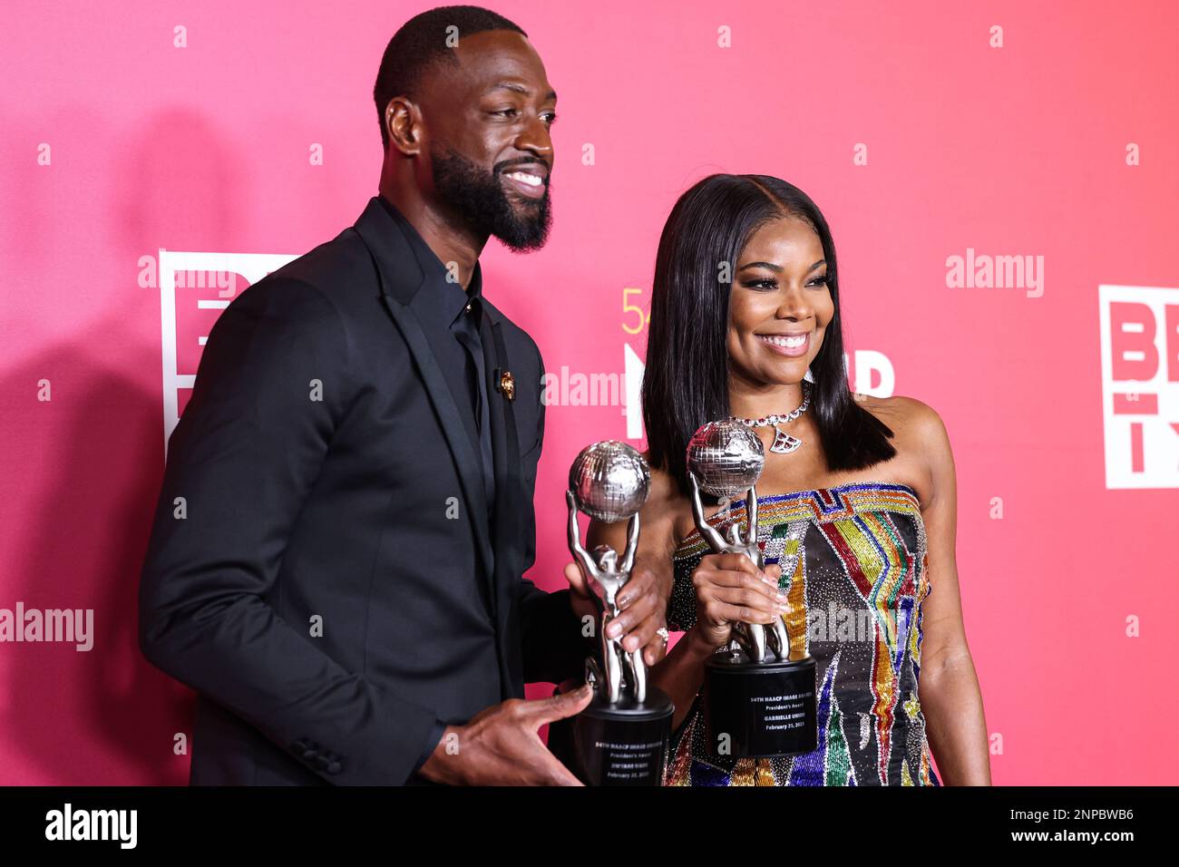 Pasadena, United States. 25th Feb, 2023. PASADENA, LOS ANGELES, CALIFORNIA, USA - FEBRUARY 25: American former professional basketball player Dwyane Wade wearing Versace and wife/American actress Gabrielle Union wearing Atelier Versace SS98 Couture, recipients of the President's Award pose in the press room at the 54th Annual NAACP Image Awards held at the Pasadena Civic Auditorium on February 25, 2023 in Pasadena, Los Angeles, California, United States. (Photo by Xavier Collin/Image Press Agency) Credit: Image Press Agency/Alamy Live News Stock Photo