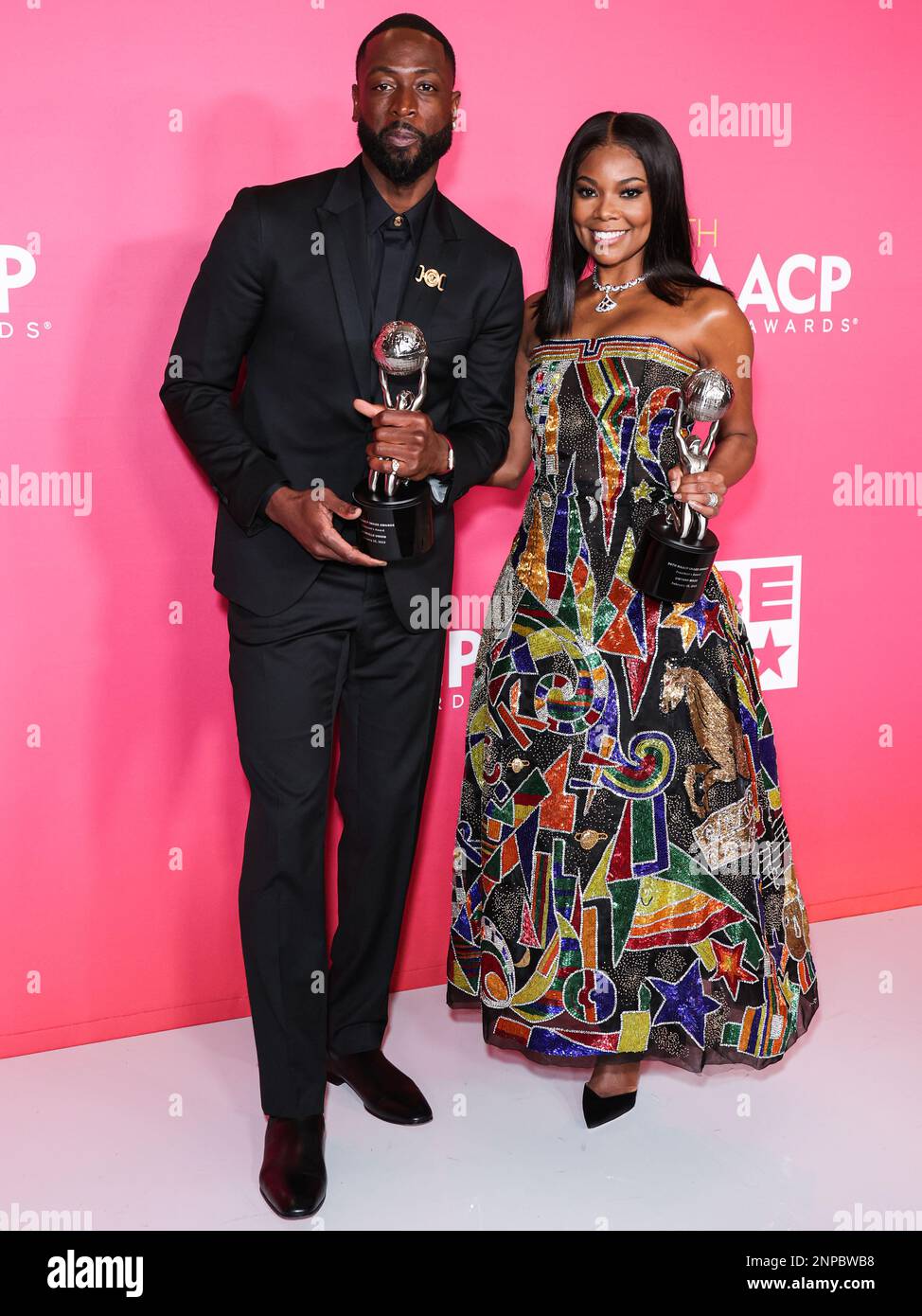 Pasadena, United States. 25th Feb, 2023. PASADENA, LOS ANGELES, CALIFORNIA, USA - FEBRUARY 25: American former professional basketball player Dwyane Wade wearing Versace and wife/American actress Gabrielle Union wearing Atelier Versace SS98 Couture, recipients of the President's Award pose in the press room at the 54th Annual NAACP Image Awards held at the Pasadena Civic Auditorium on February 25, 2023 in Pasadena, Los Angeles, California, United States. (Photo by Xavier Collin/Image Press Agency) Credit: Image Press Agency/Alamy Live News Stock Photo