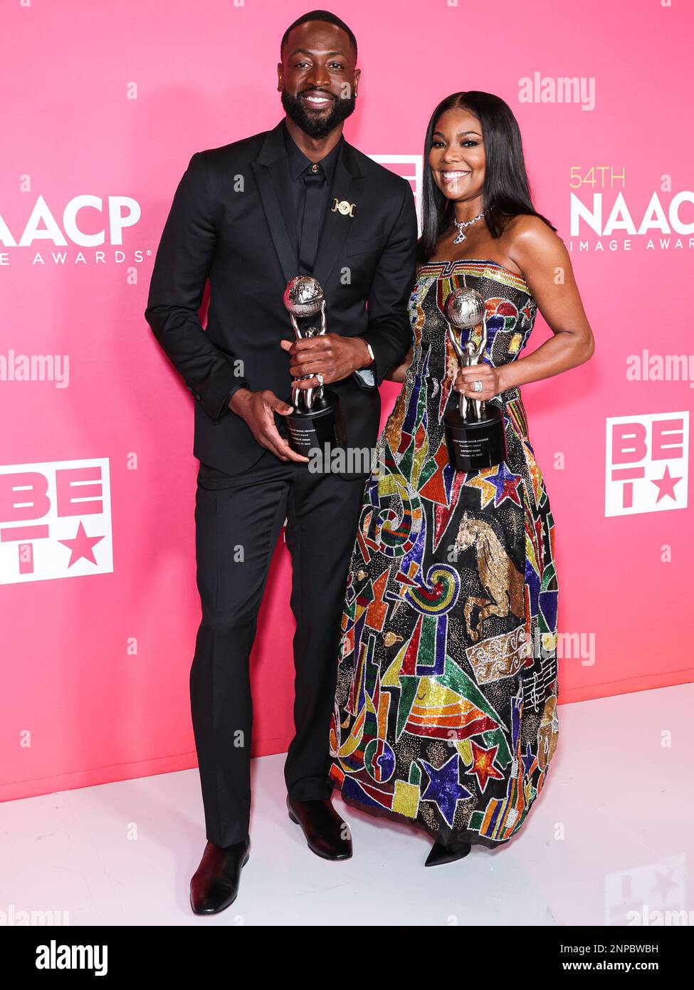 Pasadena, United States. 25th Feb, 2023. PASADENA, LOS ANGELES, CALIFORNIA, USA - FEBRUARY 25: American former professional basketball player Dwyane Wade wearing Versace and wife/American actress Gabrielle Union wearing Atelier Versace SS98 Couture, recipients of the President's Award pose in the press room at the 54th Annual NAACP Image Awards held at the Pasadena Civic Auditorium on February 25, 2023 in Pasadena, Los Angeles, California, United States. (Photo by Xavier Collin/Image Press Agency) Credit: Image Press Agency/Alamy Live News Stock Photo