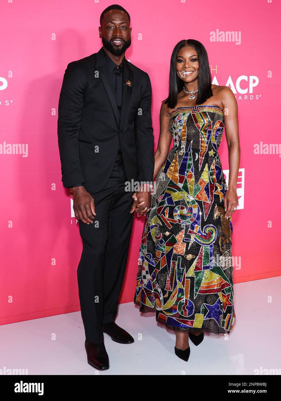 Pasadena, United States. 25th Feb, 2023. PASADENA, LOS ANGELES, CALIFORNIA, USA - FEBRUARY 25: American former professional basketball player Dwyane Wade wearing Versace and wife/American actress Gabrielle Union wearing Atelier Versace SS98 Couture, recipients of the President's Award pose in the press room at the 54th Annual NAACP Image Awards held at the Pasadena Civic Auditorium on February 25, 2023 in Pasadena, Los Angeles, California, United States. (Photo by Xavier Collin/Image Press Agency) Credit: Image Press Agency/Alamy Live News Stock Photo