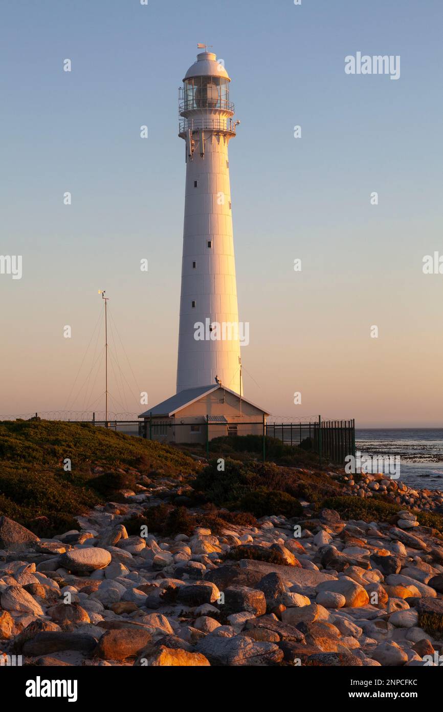 The historic 1914 cast iron Slangkop Lighthouse, Kommetjie, Cape Peninsula, Western Cape, South Africa viewed at sunset Stock Photo