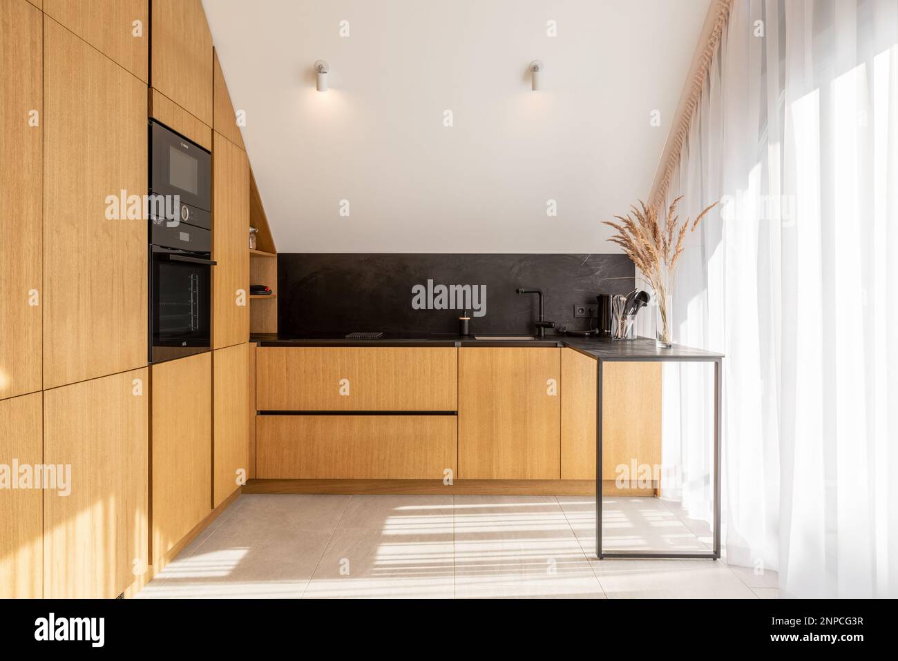 Bright Modern Kitchen in New Luxury Home, Hardwood Floors, Dark Wood Cabinets. Stock Photo