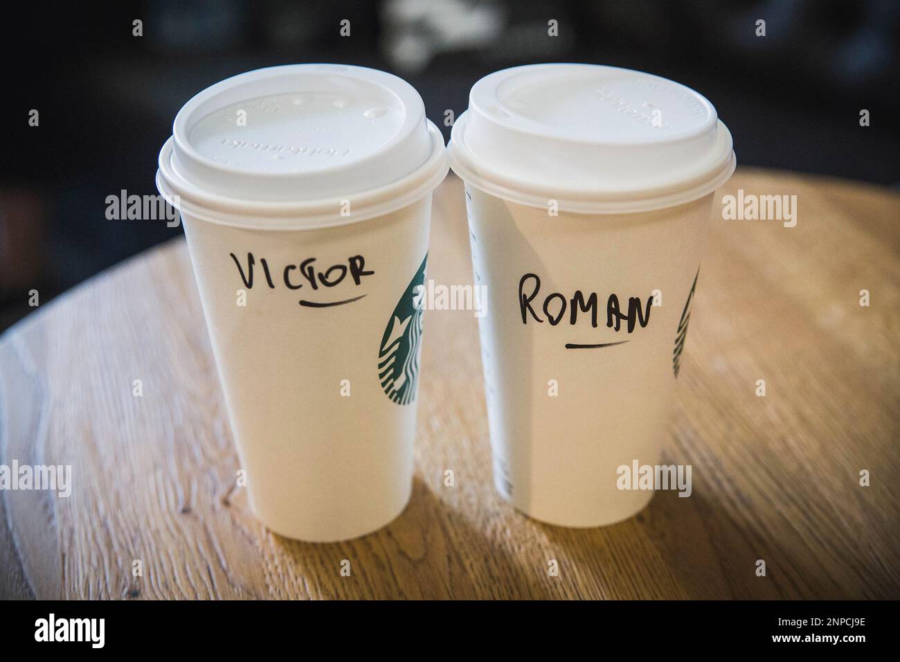 Paper coffee cups with male names at Starbucks in Poland Stock Photo