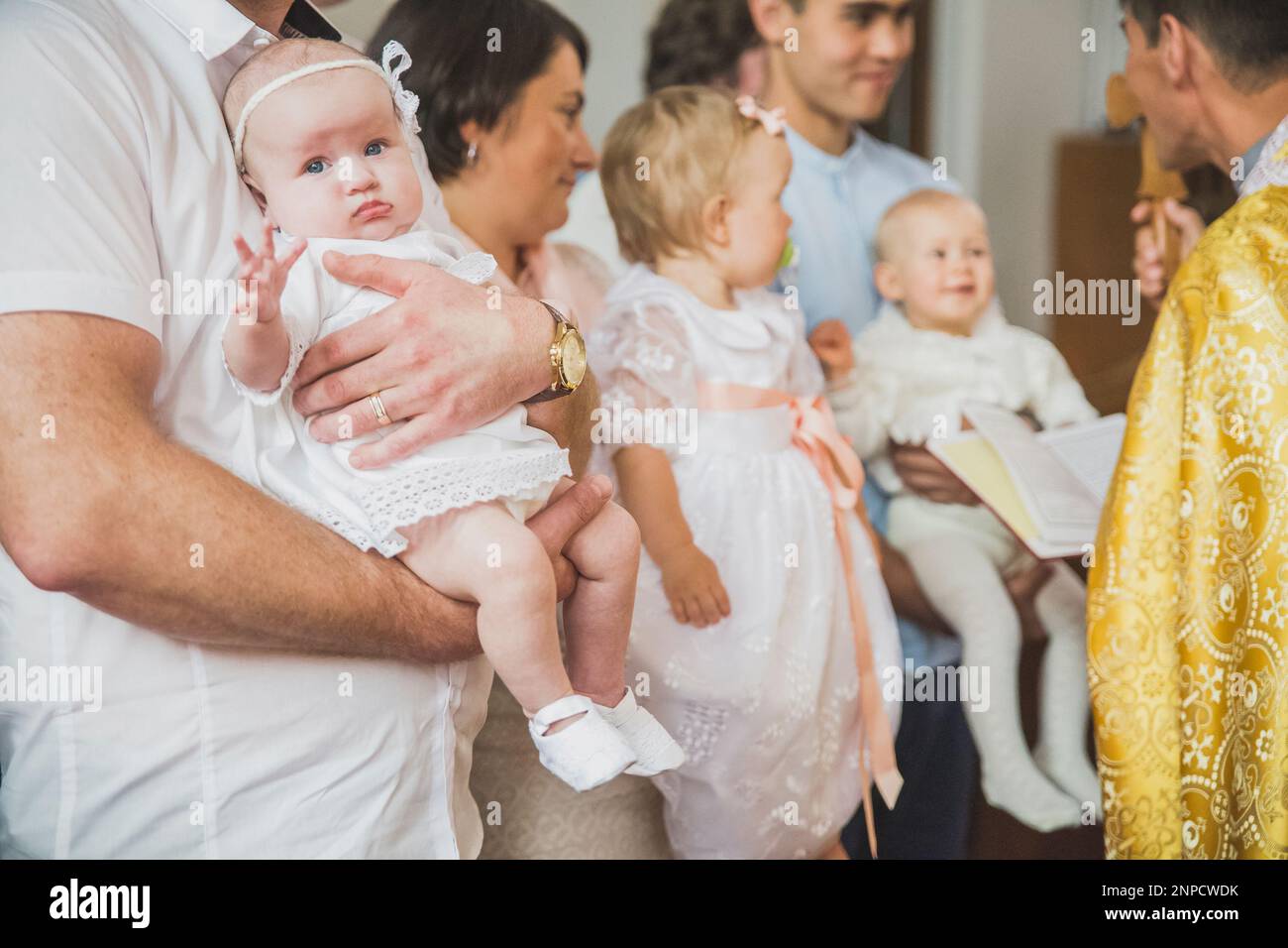 The priest conducts the rite of baptism of children in Danish Church Stock Photo