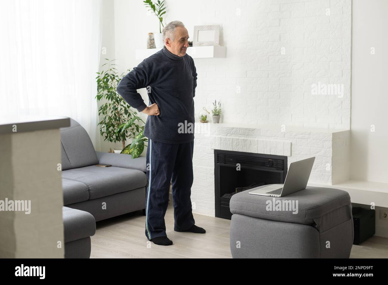 Sport in mature age. Happy middle-aged man doing stretching exercises ...