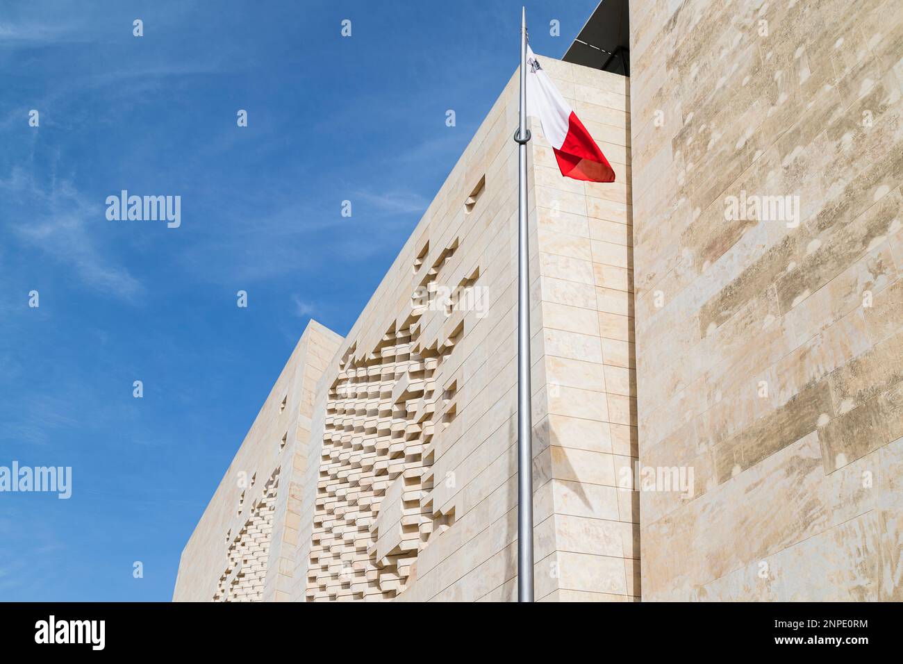 Maltese flag in front of the Parliament House pictured under a blue sky in Valletta in Malta. Stock Photo