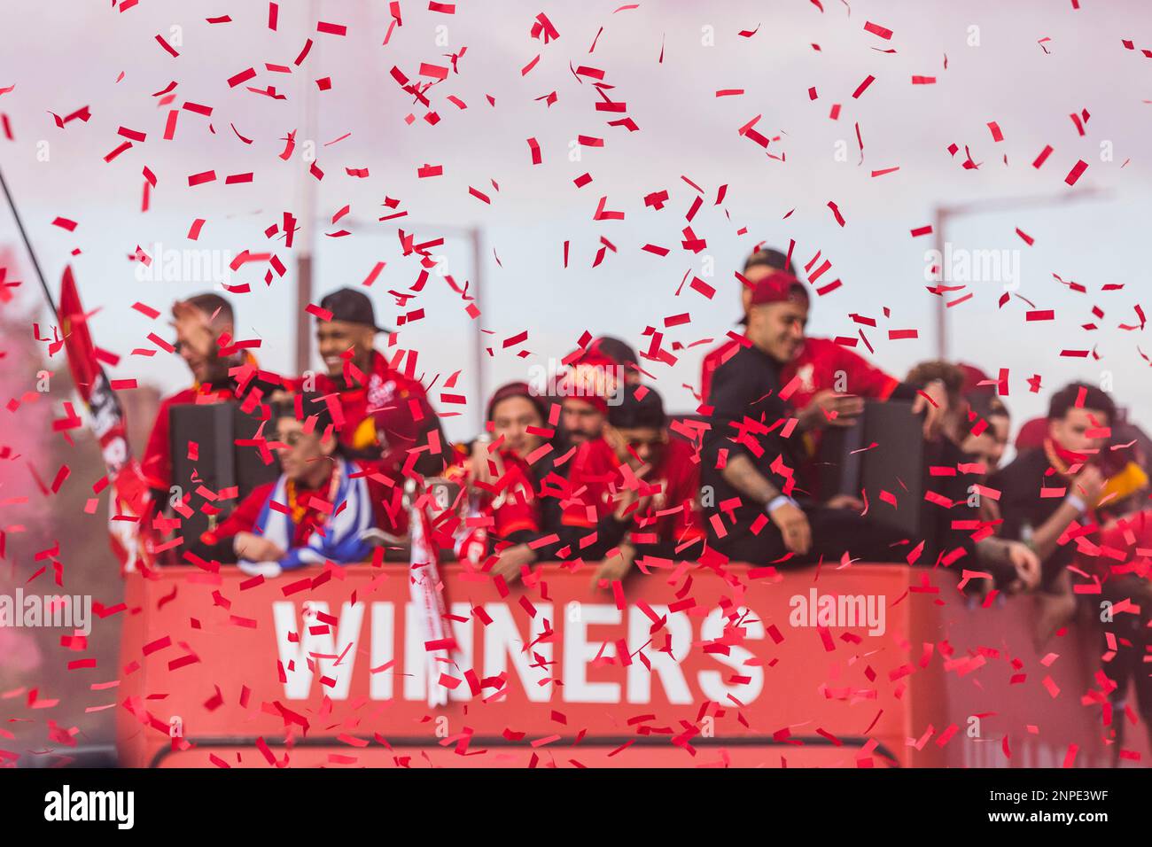 Red ticker tape in front of the Liverpool Football Club open top bus parade through the streets of Liverpool in May 2022 after winning the Carabao Cup and the FA Cup. Stock Photo