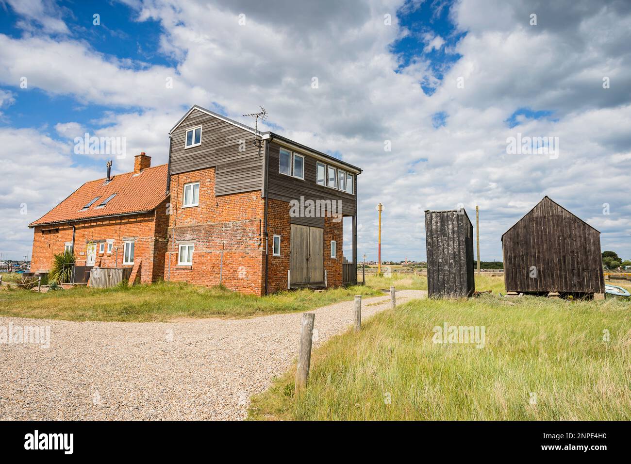 An old cottage and traditional black fishing huts on the coast at