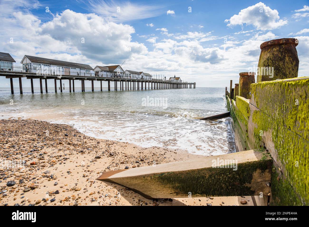 A pretty seascape of Southwold Pier seen next to a wooden groyne on the Suffolk coast. Stock Photo
