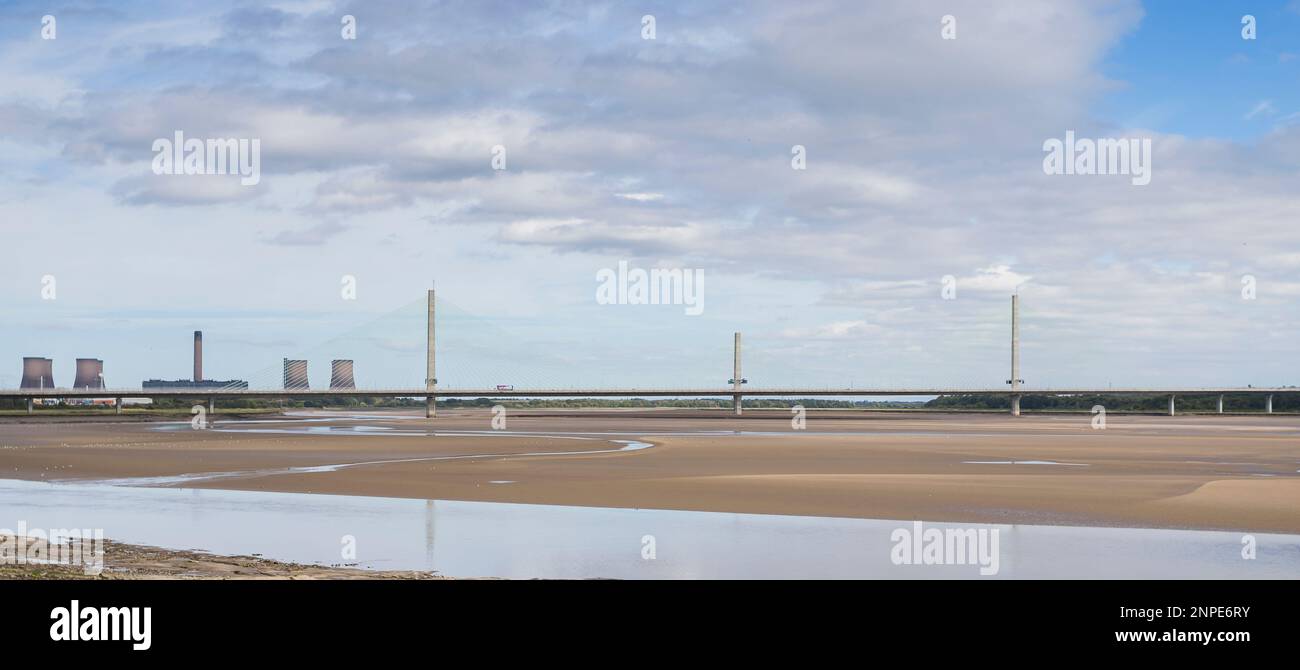 The Mersey Gateway Bridge seen connecting Runcorn and Widness in Cheshire seen spanning the River Mersey at low tide. Stock Photo