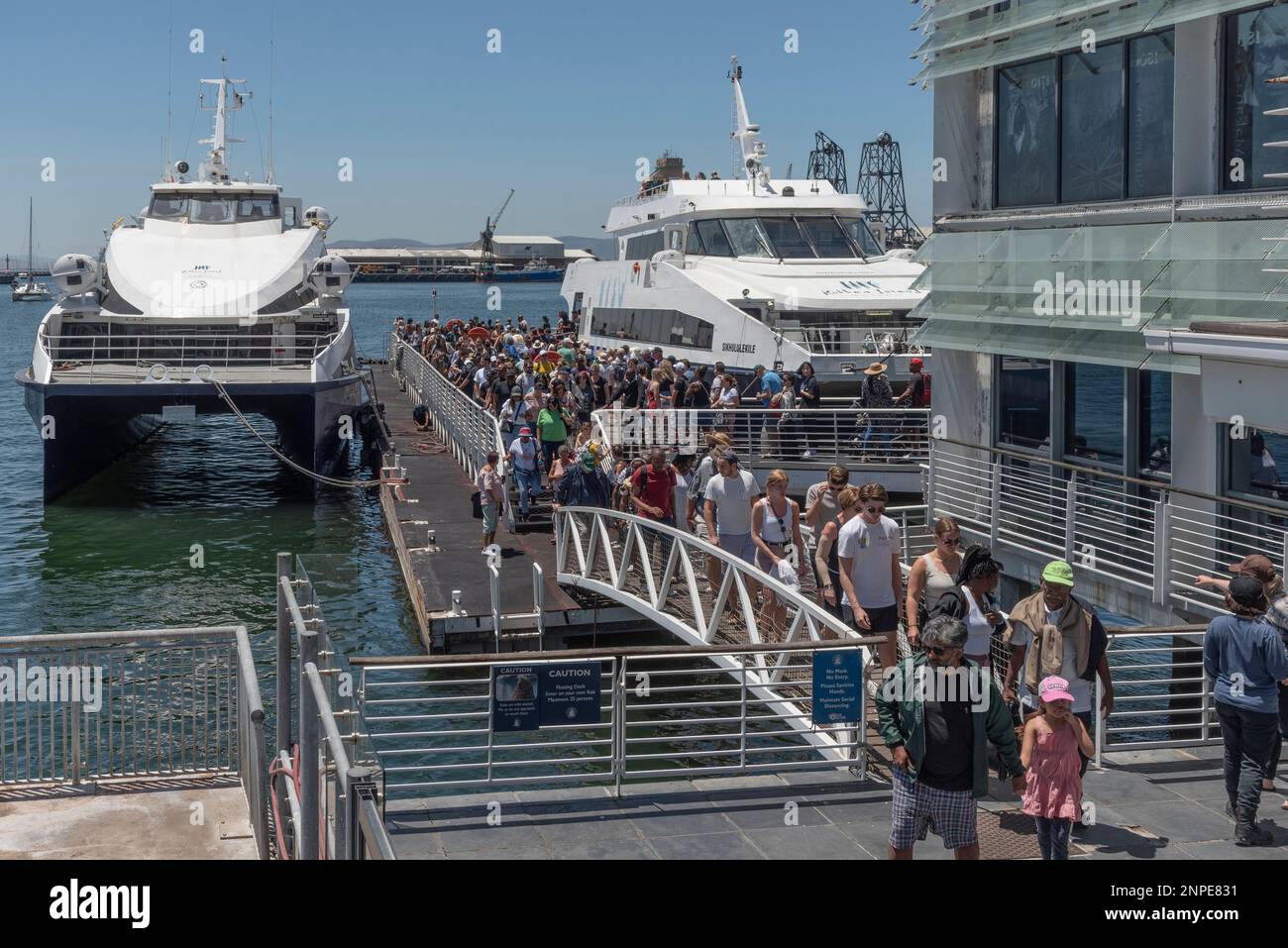 Cape Town, South Africa. 2023. Robben Island ferries with passengers embarking and disembarking