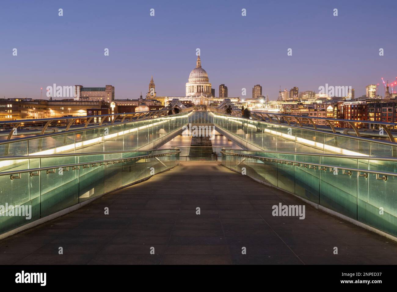 The Millennium Bridge and St Paul's Cathedral at dusk. Stock Photo