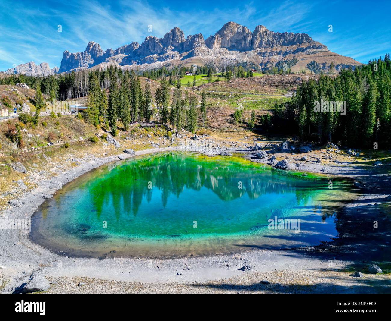 Lago di Carezza, also known as Lake Carezza or Karersee is one of the most beautiful lakes in the Dolomites region. It is known for its emerald green Stock Photo