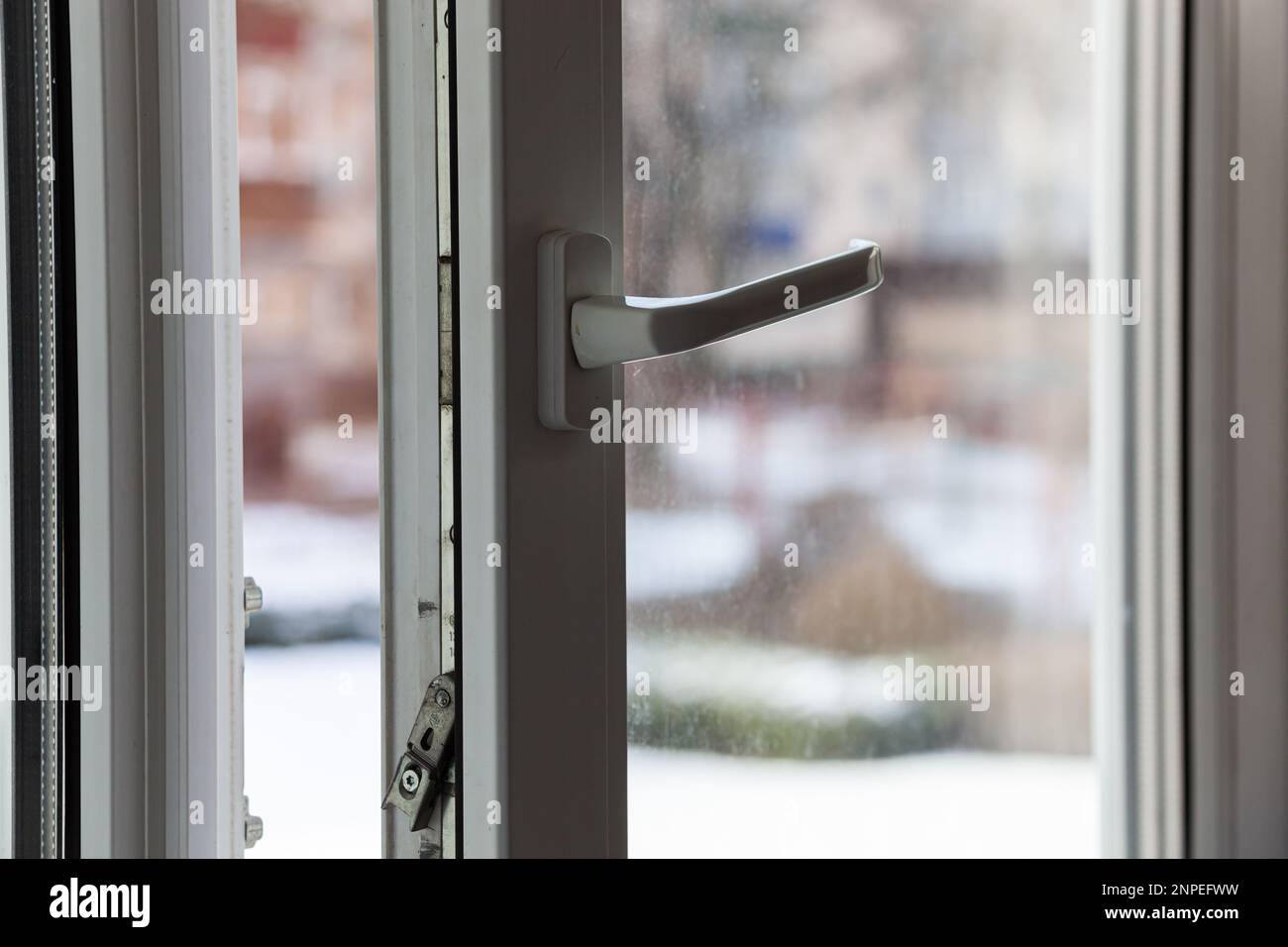 Open white plastic pvc window in winter on a cloudy day. Photo in high