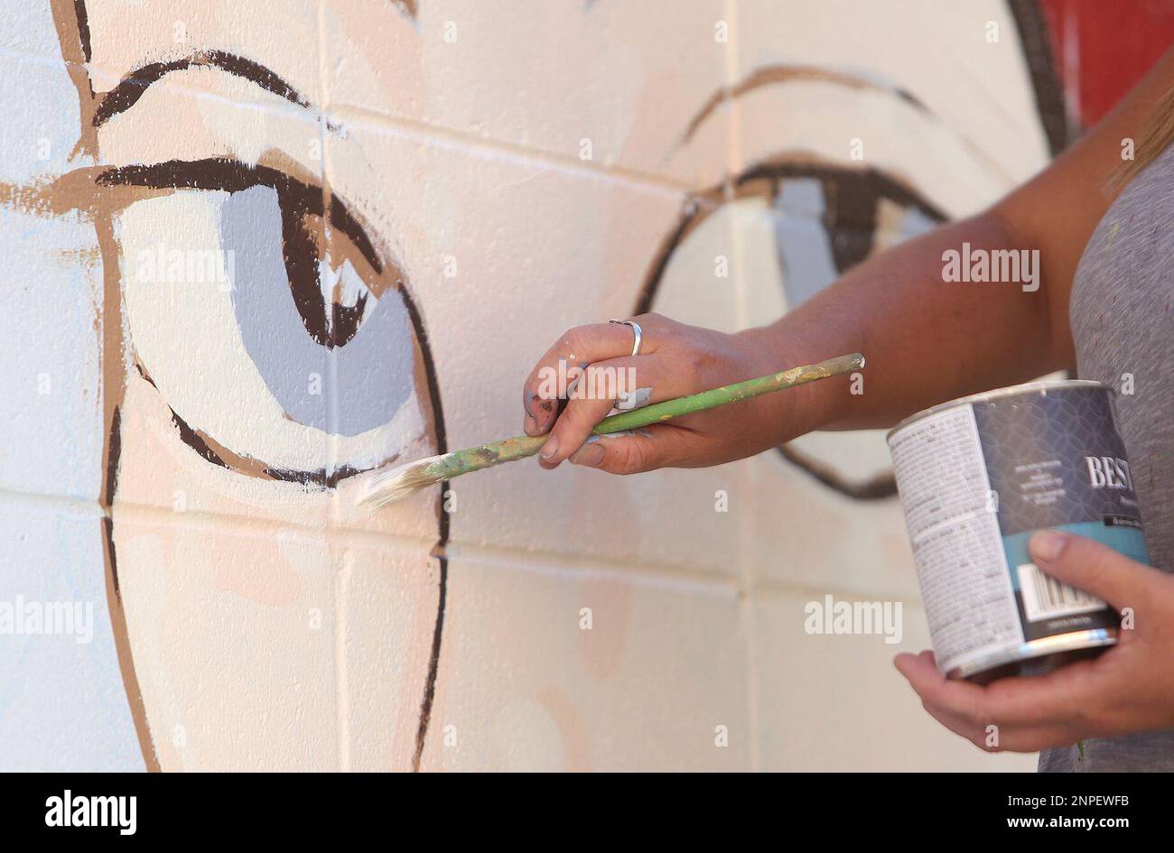 Mural artist Ursula Young adds details to the Lola Montez inspired mural going up in downtown