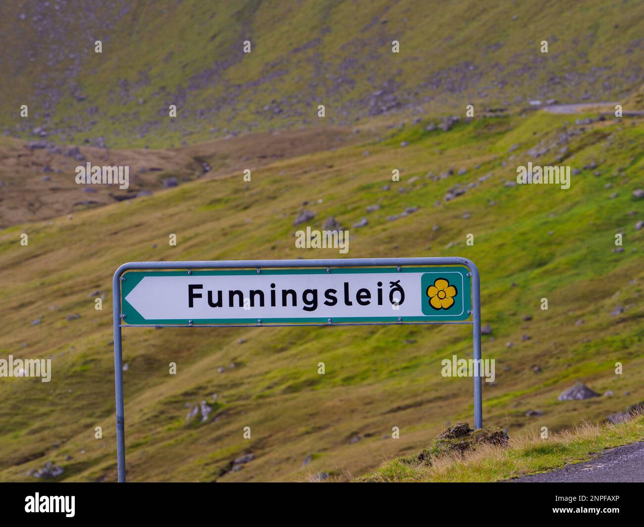 Road hiking trails in the Faroe Islands are called Sóljuleiðir in English Buttercup, from the national flower of the Faroe Islands. Sign of scenic roa Stock Photo