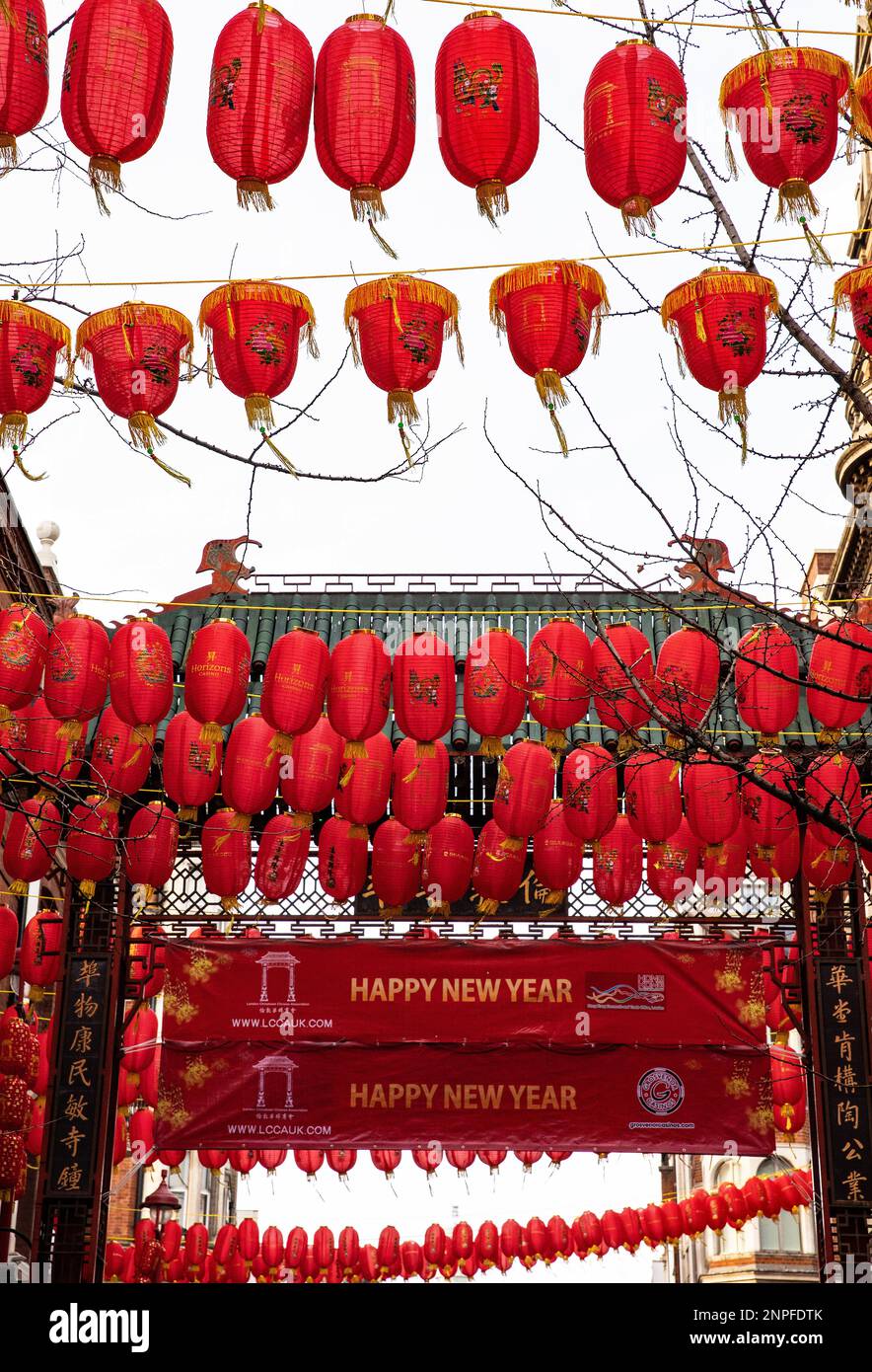 Red Chinese lanterns adorn one of the gates to Chinatown in London during the Chinese New Year celebrations Stock Photo
