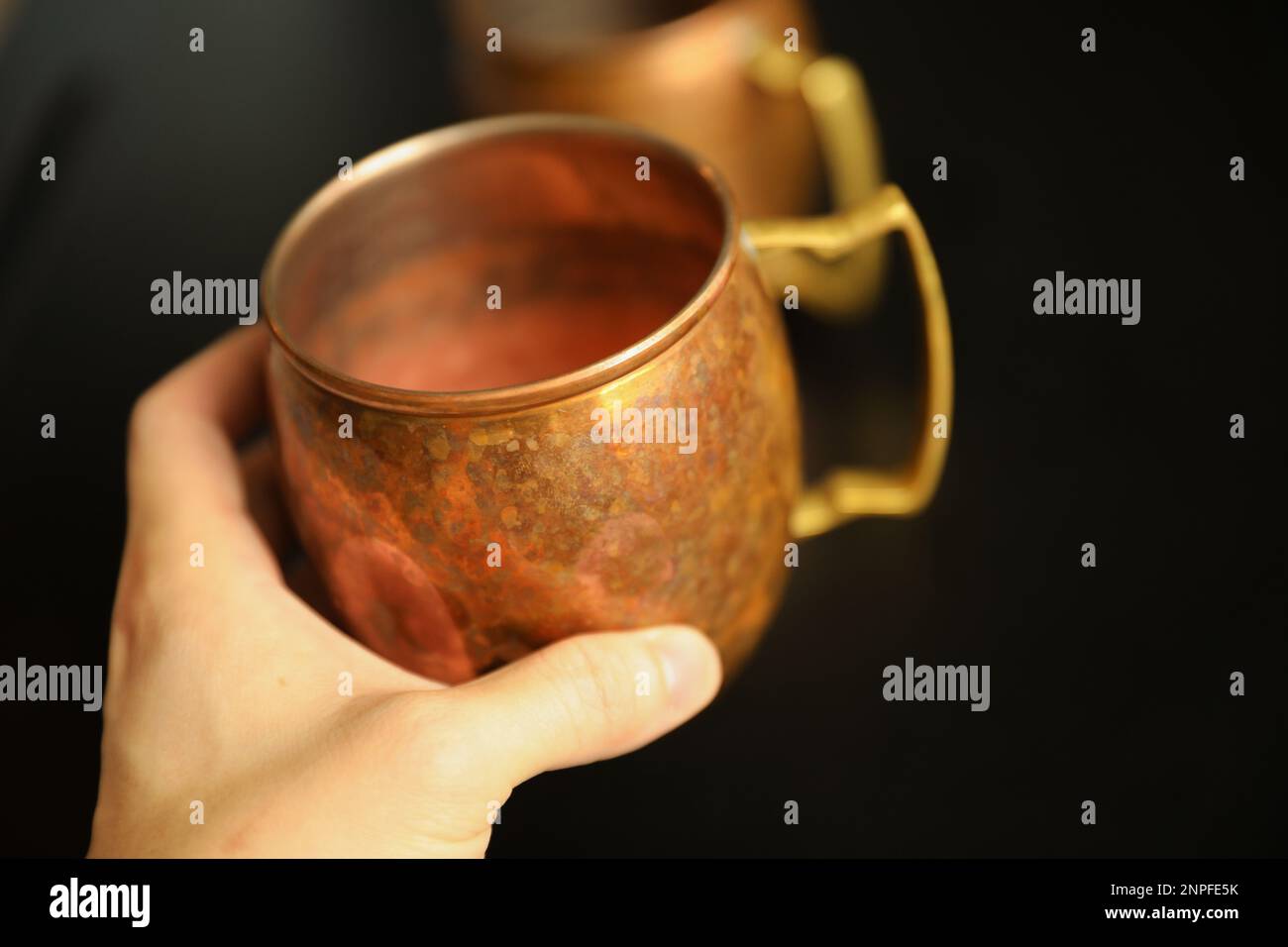 moscow mule cup holding empty golden and bronze before making a drink