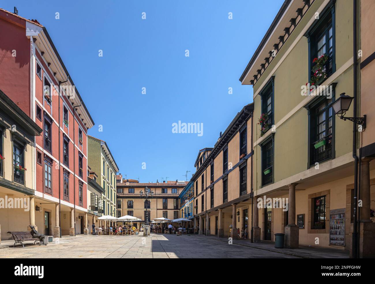 A bustling downtown plaza in Oviedo, Spain surrounded by stunning architecture and clear blue skies. Stock Photo