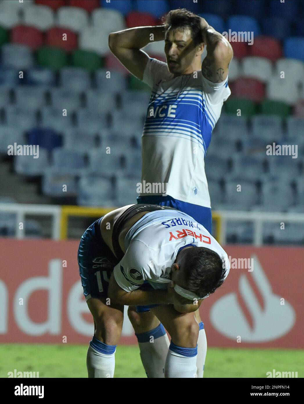 Cesar Pinares of Chile's Universidad Catolica , bottom, reacts after ...