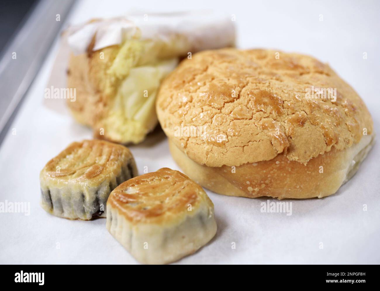 This March 29, 2019 photo shows Yummee Bakery pastries, including a  pineapple bun, right, moon cakes and sponge cake, top left, at FEED  Kitchens in Madison, Wis. Yeng Yang had tremendous success