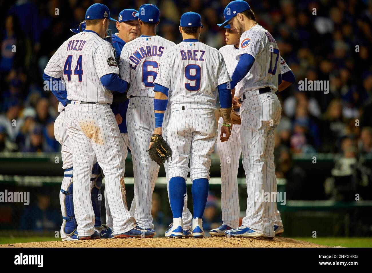 Chicago Cubs pitching coach Chris Bosio talks with pitcher Carl Edwards Jr., (6) as Wilson Contreras (40), Anthony Rizzo (44), Javier Baez (9), Kris Bryant (17), and Addison Russell (27) listen in