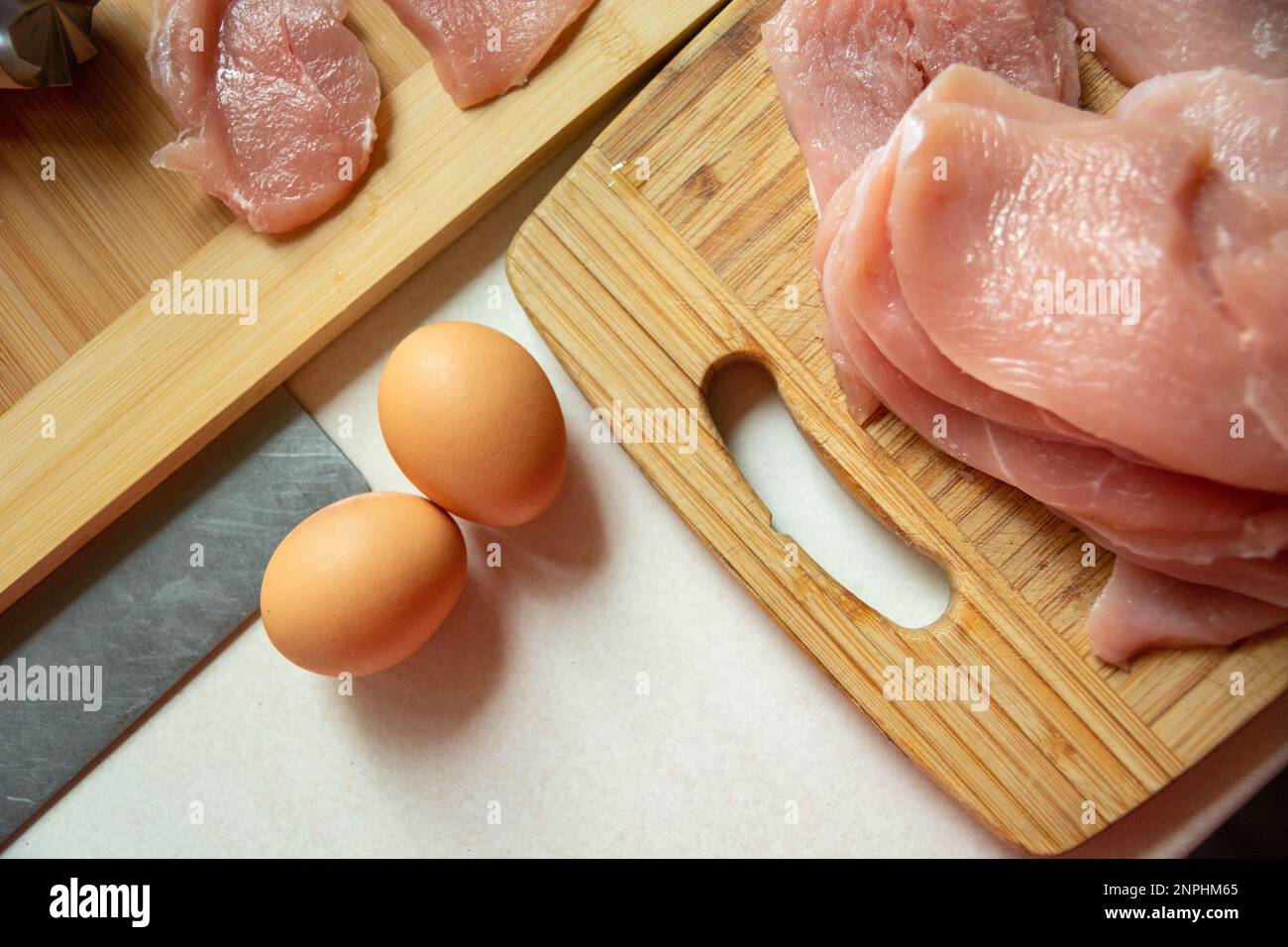 Eggs and raw meat on a kitchen board, top view Stock Photo Alamy