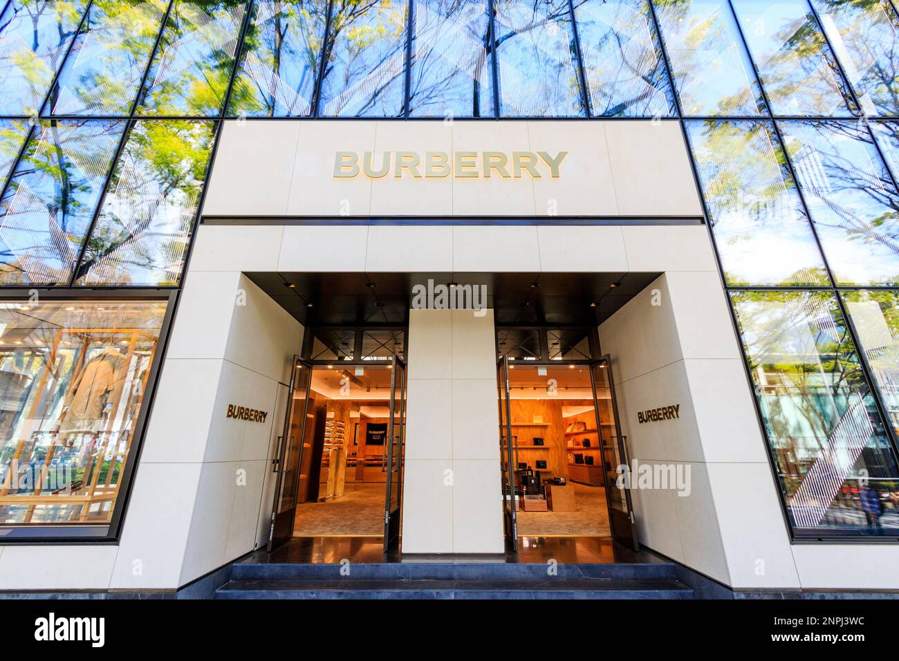 Entrance to the fashionable British Burberry store on Omotesando Avenue, Tokyo. Double entrance with store name over the top and on sides. Stock Photo