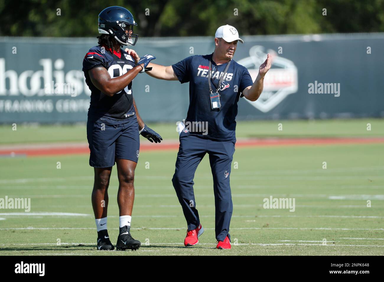 Houston Texans head coach Bill O'Brien works with tight end Jordan Akins  (88) during an NFL training camp football practice Tuesday, Aug. 25, 2020,  in Houston. (Brett Coomer/Houston Chronicle via AP, Pool