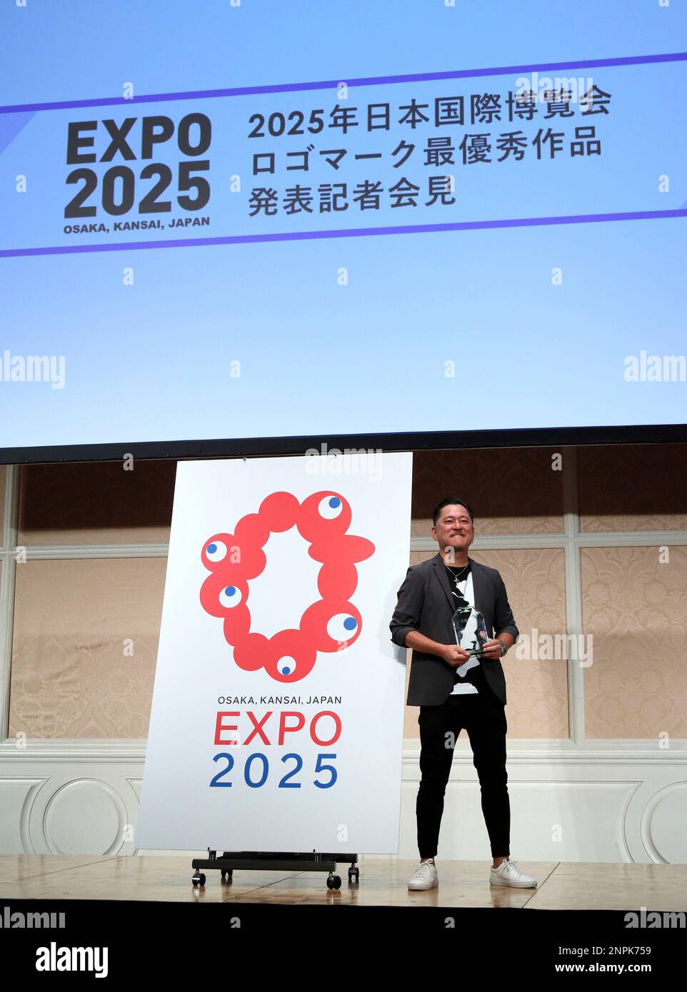 A graphic designer Tamotsu Shimada of TEAM IARI poses for photo after