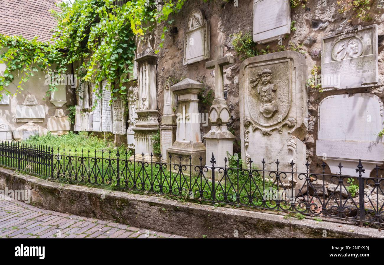 Historical slabs tombs on the exterior facade of the parish church of St. Nicholas, Merano, South Tyrol,Bolzano province, northern Italy, Europe Stock Photo