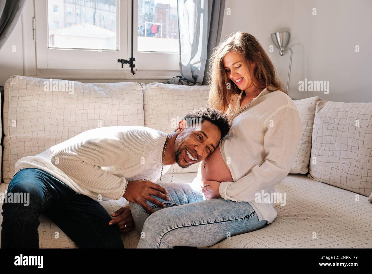 Man listening baby sound on his pregnant wife belly Stock Photo - Alamy