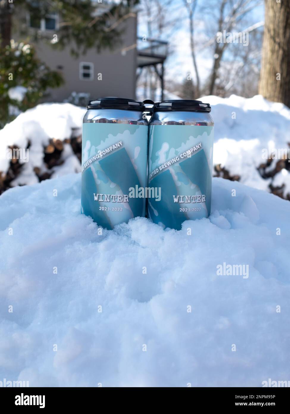 winter ale cans in the snow in winter Stock Photo